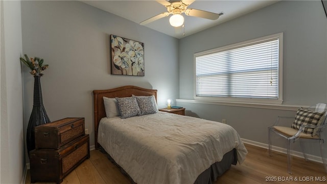 54 Palisades Lakeview Dr Unit 1B, Lake Ozark, MO 65049 - bedroom with wood finished floors and ceiling fan