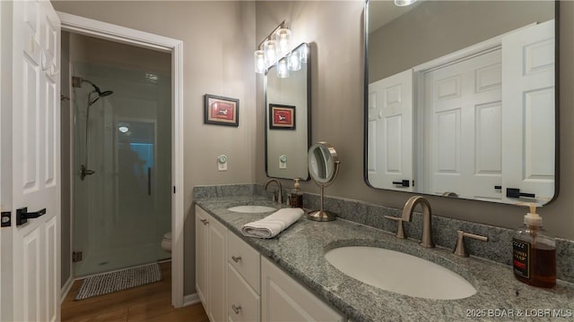 54 Palisades Lakeview Dr Unit 1B, Lake Ozark, MO 65049 - full bathroom featuring a shower stall, double vanity, and wood finished floors