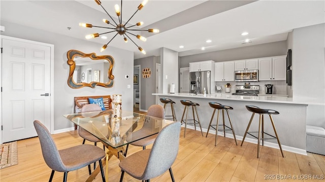 54 Palisades Lakeview Dr Unit 1B, Lake Ozark, MO 65049 - dining space with a chandelier, light wood-type flooring, and recessed lighting