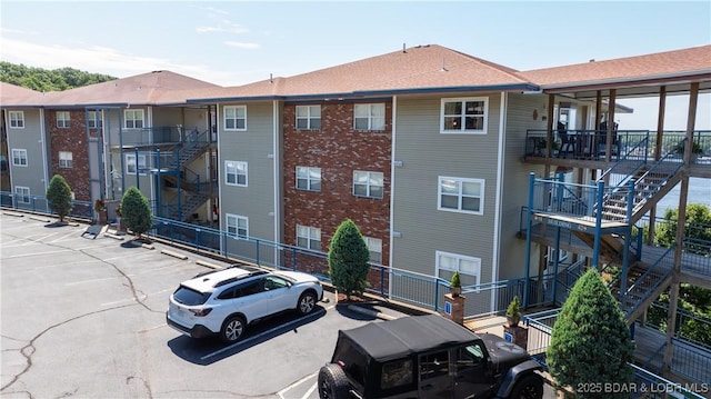54 Palisades Lakeview Dr Unit 1B, Lake Ozark, MO 65049 - view of building exterior with stairway and uncovered parking