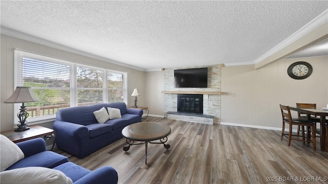 160 Bridgeview Dr, Camdenton, MO 65020 - living area with crown molding, wood finished floors, a textured ceiling, and a fireplace