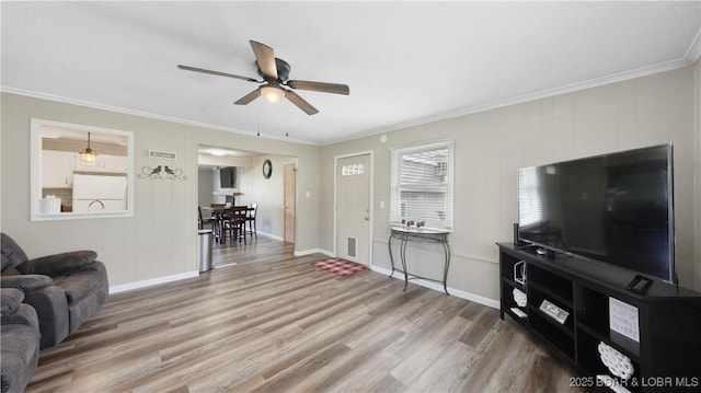 160 Bridgeview Dr, Camdenton, MO 65020 - living area with crown molding, a ceiling fan, and wood finished floors