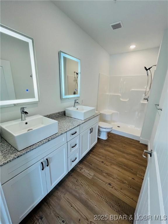 295 Highland Shores Dr Unit 5F, Lake Ozark, MO 65049 - bathroom featuring wood finished floors, walk in shower, and double vanity