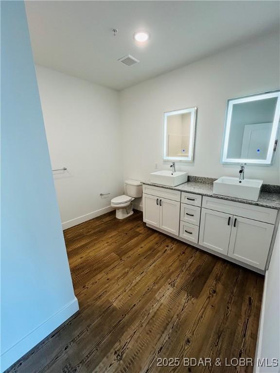 295 Highland Shores Dr Unit 5F, Lake Ozark, MO 65049 - full bathroom featuring double vanity and wood finished floors