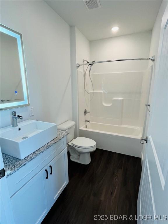 295 Highland Shores Dr Unit 4D, Lake Ozark, MO 65049 - full bath featuring vanity, wood finished floors, and tub / shower combination
