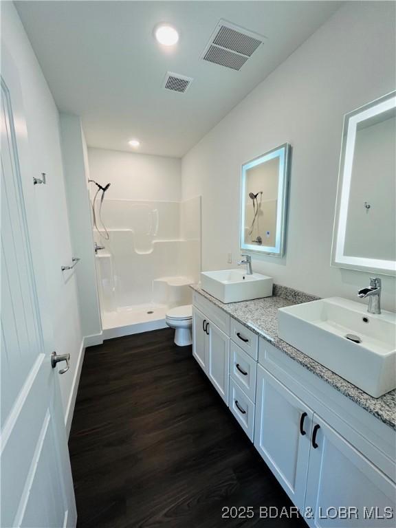 295 Highland Shores Dr Unit 4D, Lake Ozark, MO 65049 - bathroom featuring walk in shower, wood finished floors, double vanity, and recessed lighting