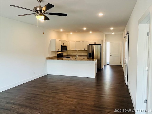 295 Highland Shores Dr Unit 4D, Lake Ozark, MO 65049 - kitchen featuring stainless steel appliances, a peninsula, dark wood-style floors, recessed lighting, and a ceiling fan