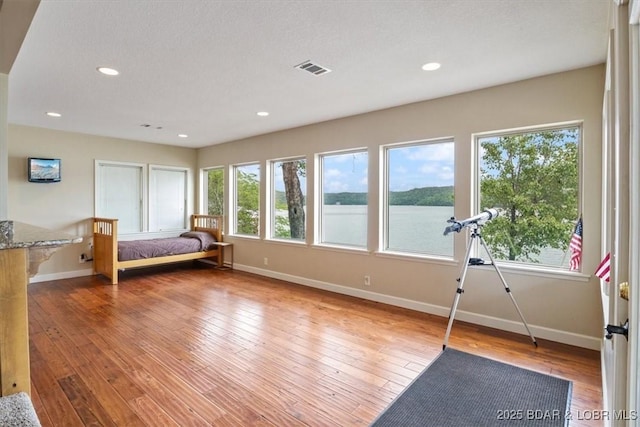 97 Random Rd, Edwards, MO 65326 - bedroom with recessed lighting, hardwood / wood-style floors, and a water view