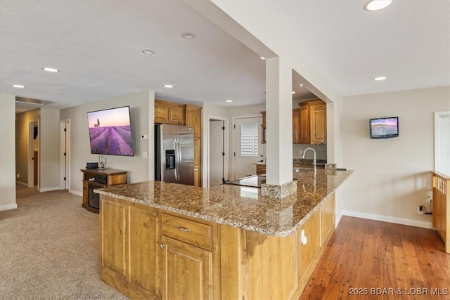 97 Random Rd, Edwards, MO 65326 - kitchen with stainless steel fridge with ice dispenser, a peninsula, stone counters, recessed lighting, and electric stovetop