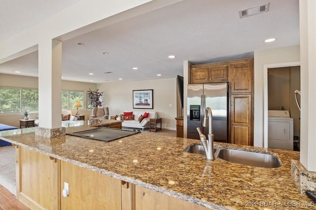 97 Random Rd, Edwards, MO 65326 - kitchen with washer / clothes dryer, stainless steel fridge with ice dispenser, light stone countertops, electric stovetop, and recessed lighting
