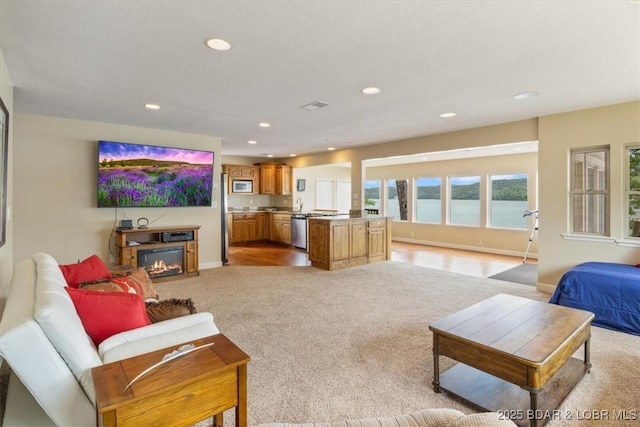 97 Random Rd, Edwards, MO 65326 - living area featuring light colored carpet, recessed lighting, and a glass covered fireplace