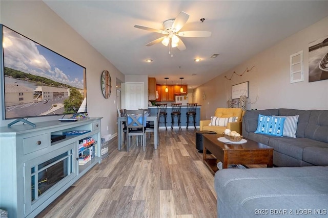 1481 Ledges Dr Unit C24, Osage Beach, MO 65065 - living room with light wood-style flooring and ceiling fan