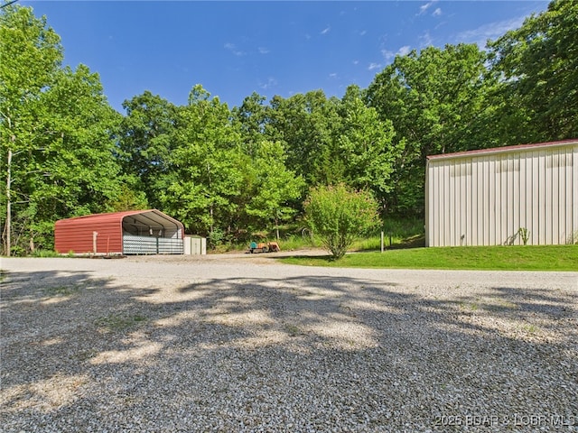 1620 Triple Cove Ln, Climax Springs, MO 65324 - view of yard featuring gravel driveway, a carport, and an outdoor structure