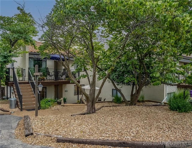 35 Casa Blanca Ct Unit 220-1A, Lake Ozark, MO 65049 - rear view of property with stucco siding and stairway