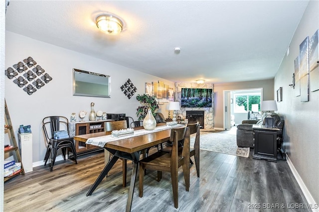 35 Casa Blanca Ct Unit 220-1A, Lake Ozark, MO 65049 - dining space with wood finished floors and a stone fireplace