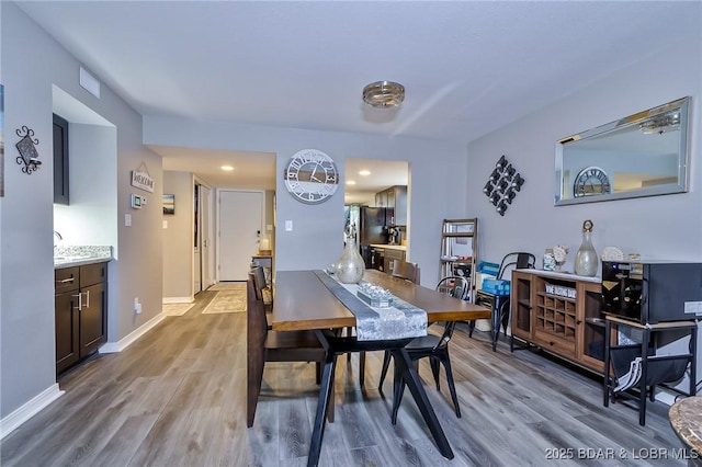 35 Casa Blanca Ct Unit 220-1A, Lake Ozark, MO 65049 - dining space featuring wood finished floors and recessed lighting
