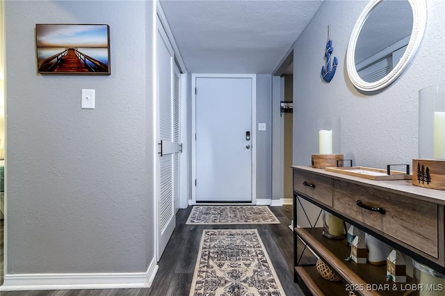 35 Casa Blanca Ct Unit 220-1A, Lake Ozark, MO 65049 - hall featuring dark wood-style floors, a textured wall, and a textured ceiling