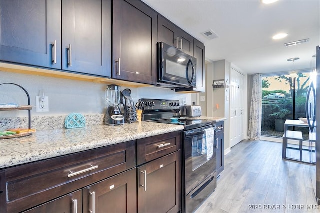 35 Casa Blanca Ct Unit 220-1A, Lake Ozark, MO 65049 - kitchen featuring black appliances, light wood-style flooring, light stone counters, dark brown cabinets, and recessed lighting