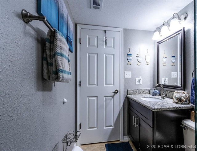 35 Casa Blanca Ct Unit 220-1A, Lake Ozark, MO 65049 - bathroom featuring vanity, a textured wall, a textured ceiling, and tile patterned floors