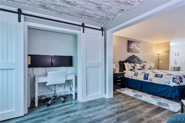 35 Casa Blanca Ct Unit 220-1A, Lake Ozark, MO 65049 - bedroom featuring a barn door, wood finished floors, and an office area