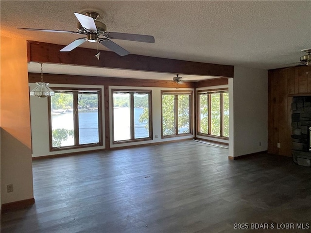 192 Ke Jo Point Rd, Gravois Mills, MO 65037 - unfurnished living room featuring a textured ceiling, dark wood-style floors, a fireplace, and a ceiling fan