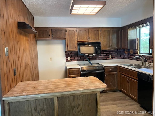 192 Ke Jo Point Rd, Gravois Mills, MO 65037 - kitchen with black appliances, butcher block countertops, light wood-style flooring, wood walls, and a textured ceiling