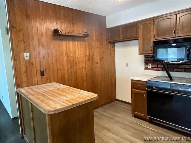 192 Ke Jo Point Rd, Gravois Mills, MO 65037 - kitchen featuring black microwave, stove, wooden walls, light wood-style floors, and butcher block countertops