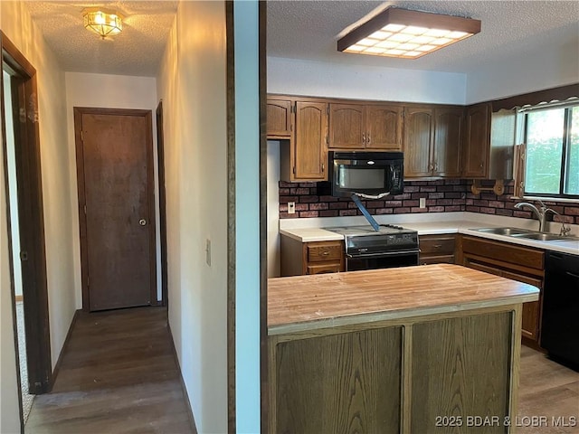 192 Ke Jo Point Rd, Gravois Mills, MO 65037 - kitchen with black appliances, wood counters, wood finished floors, a textured ceiling, and backsplash