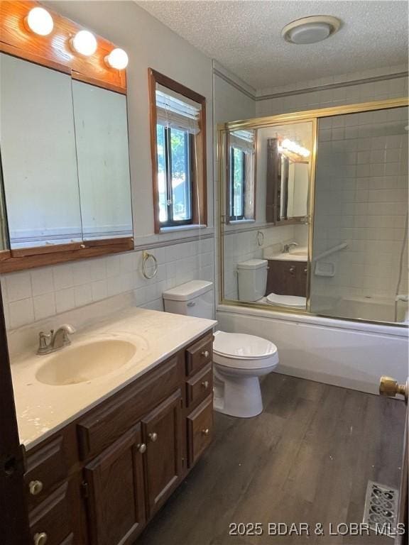 192 Ke Jo Point Rd, Gravois Mills, MO 65037 - full bathroom featuring a textured ceiling, vanity, wood finished floors, bath / shower combo with glass door, and tasteful backsplash