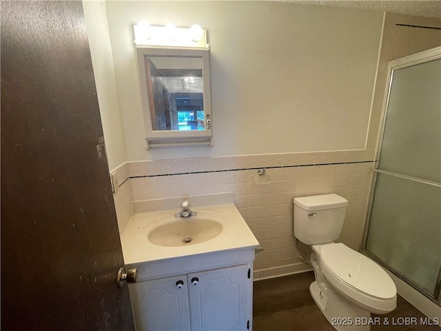192 Ke Jo Point Rd, Gravois Mills, MO 65037 - bathroom with vanity, an enclosed shower, wainscoting, and tile walls