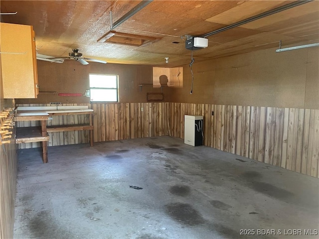 192 Ke Jo Point Rd, Gravois Mills, MO 65037 - garage with a garage door opener, a workshop area, wooden walls, and wainscoting