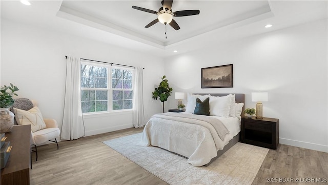 3164 Cross Creek Dr, Camdenton, MO 65020 - bedroom featuring a raised ceiling, light wood-type flooring, recessed lighting, and ceiling fan