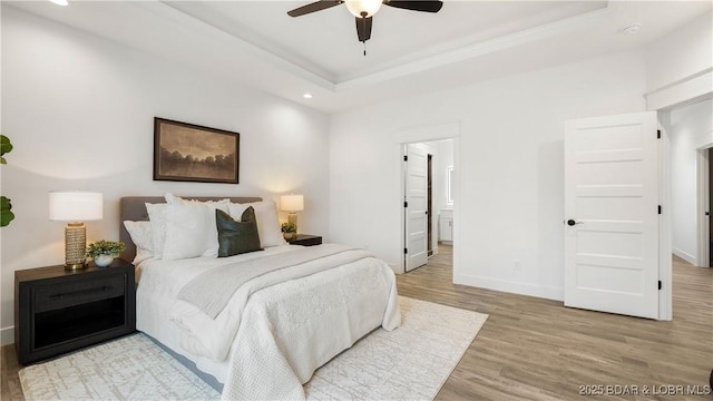 3164 Cross Creek Dr, Camdenton, MO 65020 - bedroom featuring light wood-style flooring, recessed lighting, a raised ceiling, ensuite bath, and crown molding