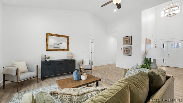 3164 Cross Creek Dr, Camdenton, MO 65020 - living area featuring high vaulted ceiling, light wood-style floors, ceiling fan, and a chandelier