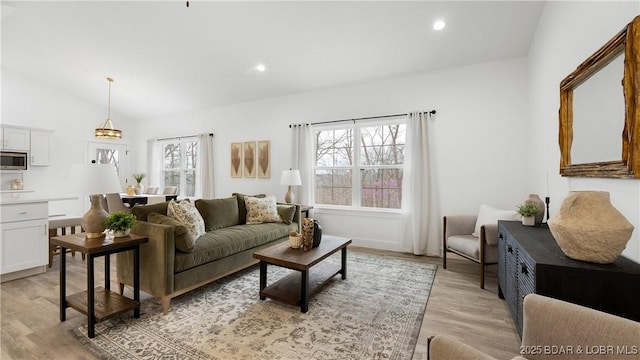 3164 Cross Creek Dr, Camdenton, MO 65020 - living area with plenty of natural light, light wood finished floors, vaulted ceiling, and recessed lighting