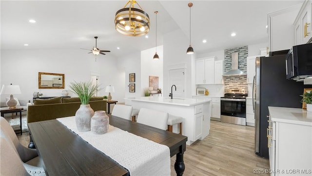 3164 Cross Creek Dr, Camdenton, MO 65020 - dining space featuring a ceiling fan, recessed lighting, vaulted ceiling, and light wood-style flooring