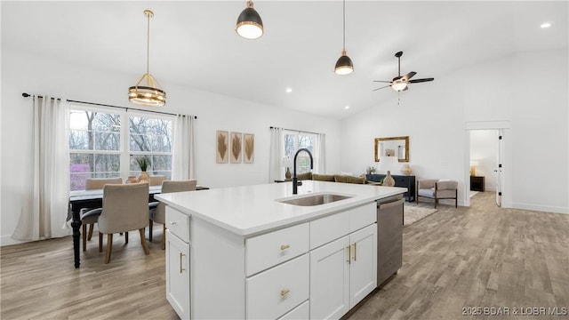 3164 Cross Creek Dr, Camdenton, MO 65020 - kitchen featuring vaulted ceiling, a ceiling fan, light wood finished floors, dishwasher, and pendant lighting