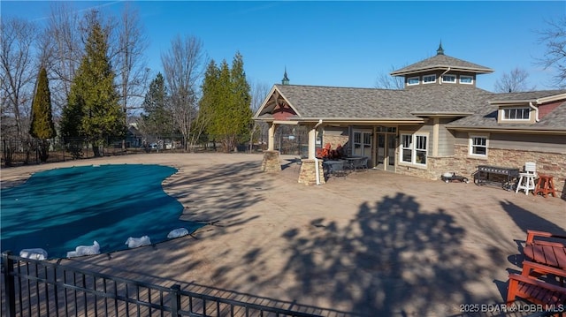 3164 Cross Creek Dr, Camdenton, MO 65020 - rear view of property featuring stone siding, a patio, and a shingled roof