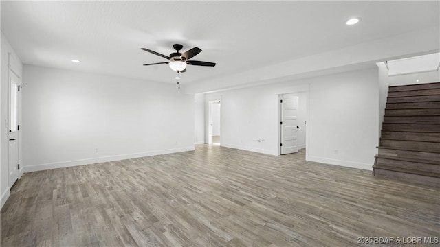 3164 Cross Creek Dr, Camdenton, MO 65020 - unfurnished living room featuring ceiling fan, stairs, wood finished floors, and recessed lighting