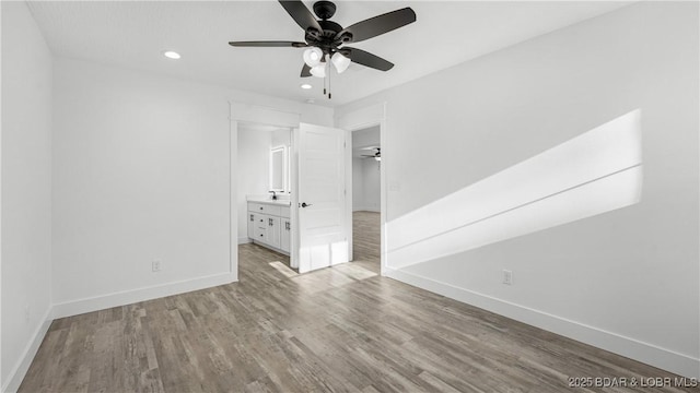 3164 Cross Creek Dr, Camdenton, MO 65020 - unfurnished bedroom featuring recessed lighting, wood finished floors, a walk in closet, ensuite bath, and ceiling fan