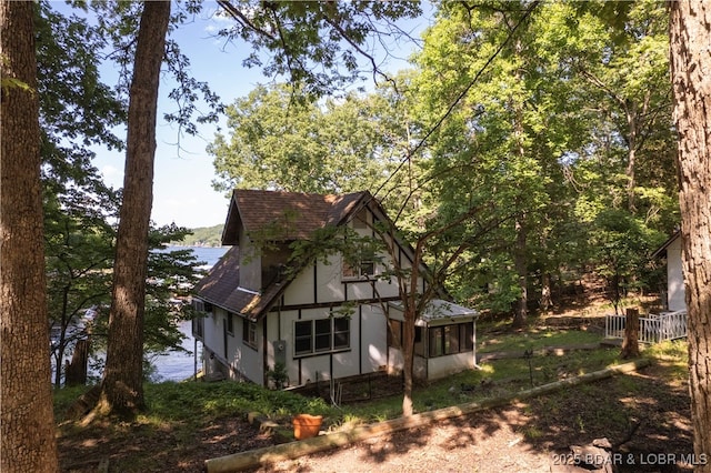 15617 Santa Fe Trl, Gravois Mills, MO 65037 - view of side of home featuring roof with shingles