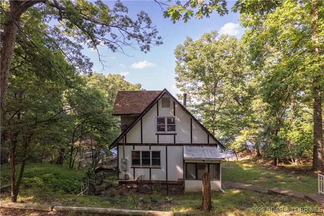 15617 Santa Fe Trl, Gravois Mills, MO 65037 - rear view of property featuring a yard