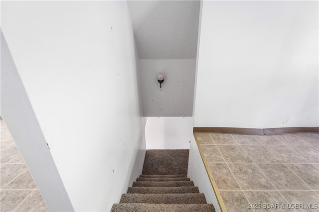 15617 Santa Fe Trl, Gravois Mills, MO 65037 - staircase featuring a textured ceiling and tile patterned floors
