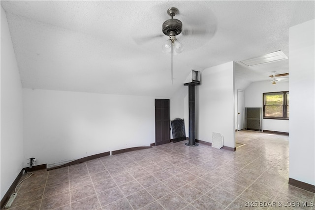15617 Santa Fe Trl, Gravois Mills, MO 65037 - unfurnished living room with vaulted ceiling, a ceiling fan, and a textured ceiling