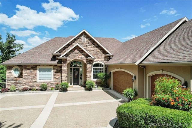 1163 Beacon Pointe Cir, Lake Ozark, MO 65049 - french country inspired facade featuring an attached garage, stone siding, stucco siding, and roof with shingles