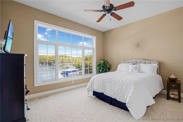 1163 Beacon Pointe Cir, Lake Ozark, MO 65049 - bedroom featuring carpet floors, a water view, and a ceiling fan