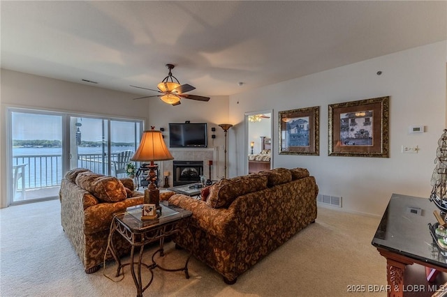 492 Regatta Bay Dr Unit 2D, Lake Ozark, MO 65049 - carpeted living room featuring ceiling fan and a fireplace