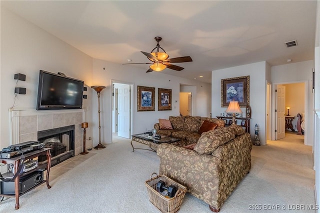 492 Regatta Bay Dr Unit 2D, Lake Ozark, MO 65049 - living area featuring light colored carpet, ceiling fan, and a tile fireplace
