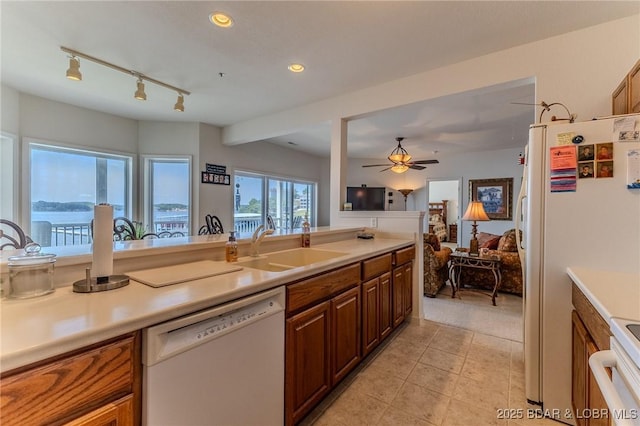 492 Regatta Bay Dr Unit 2D, Lake Ozark, MO 65049 - kitchen with white appliances, light tile patterned flooring, light countertops, brown cabinets, and recessed lighting