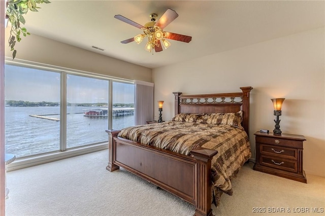492 Regatta Bay Dr Unit 2D, Lake Ozark, MO 65049 - bedroom featuring light carpet, access to exterior, and a water view